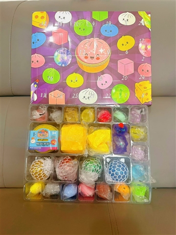 Close-up of the Mystery Baozi 24-Day Fidget Squishy Countdown Calendar revealing assorted mini squishies with different internal fillings, including PP cotton, gold powder, and colored-bead versions.